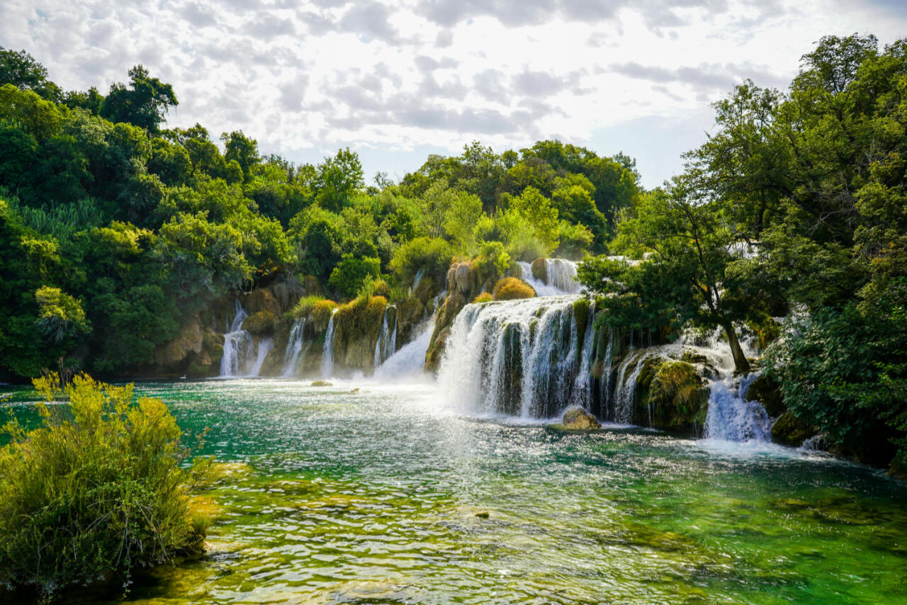 Krka National Park is a stunning highlight of yacht charter Croatia, famous for its waterfalls, emerald river, and scenic sailing route to Skradin.